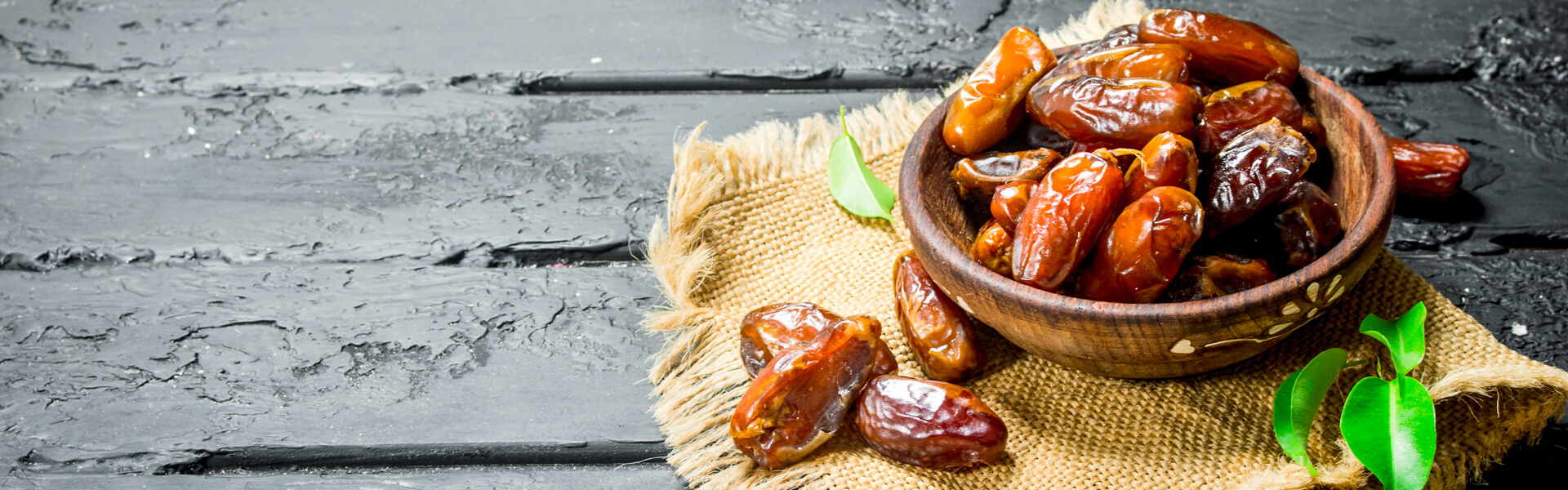 dates-with-a-bowl-with-green-leaves-UZJ4KQ3